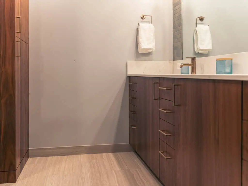 Floor-to-ceiling tile with champagne bronze fixtures