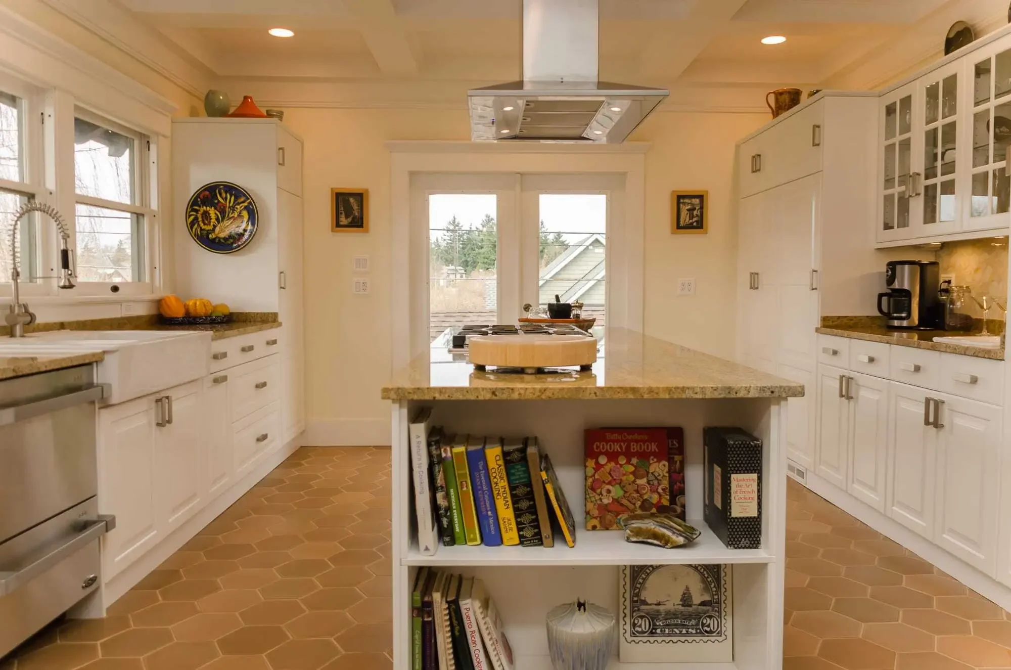 Site-built custom bookshelves cap the end of the kitchen island