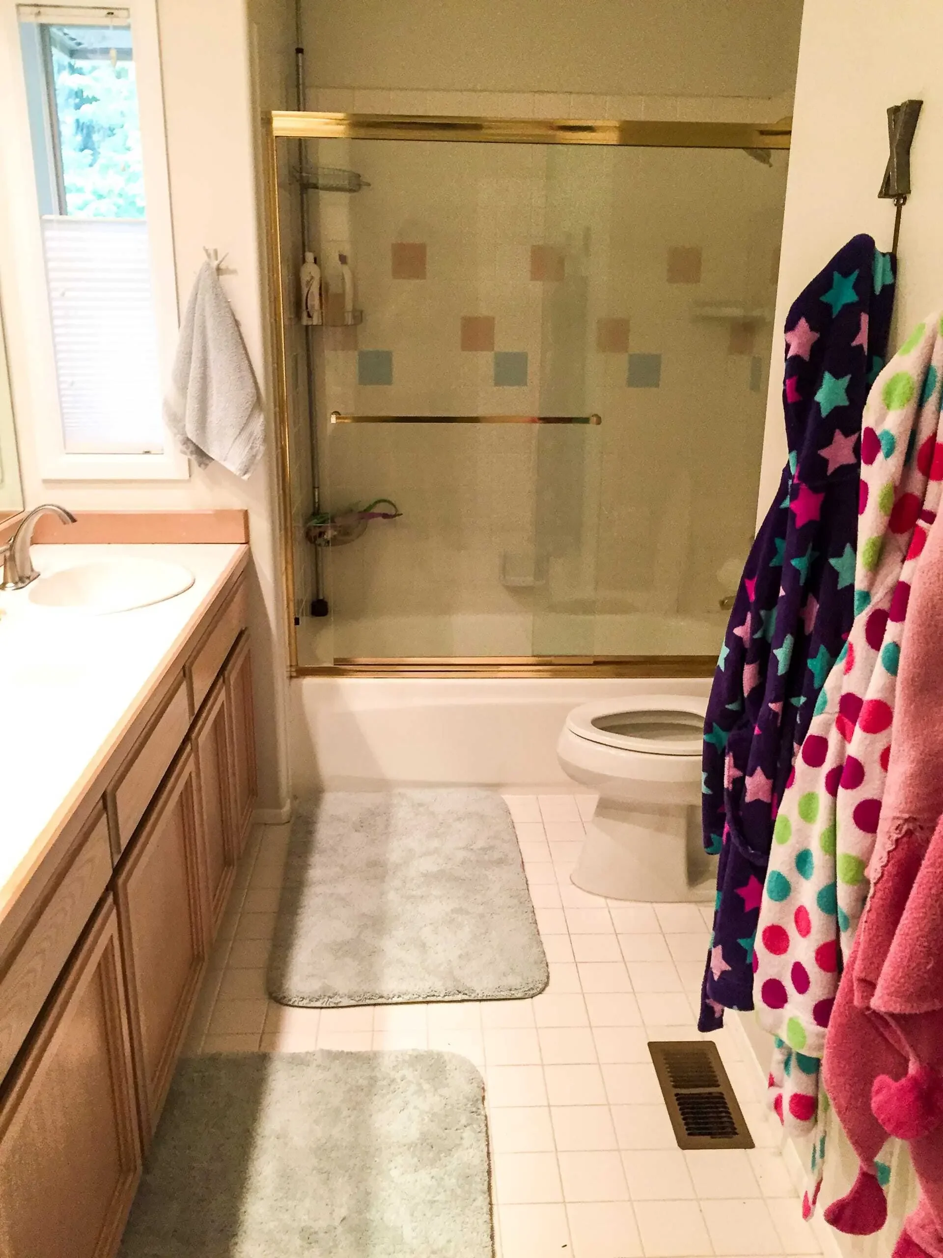 Toilet in front of shower. What an eyesore!