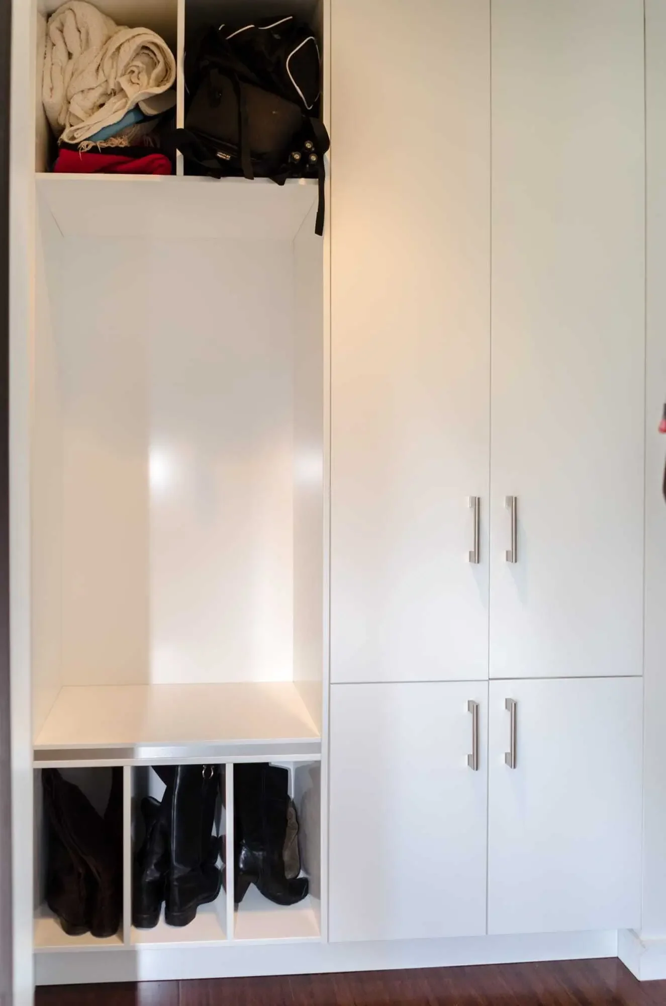 Mud room storage with built-in bench and open cubbies for shoes and bags