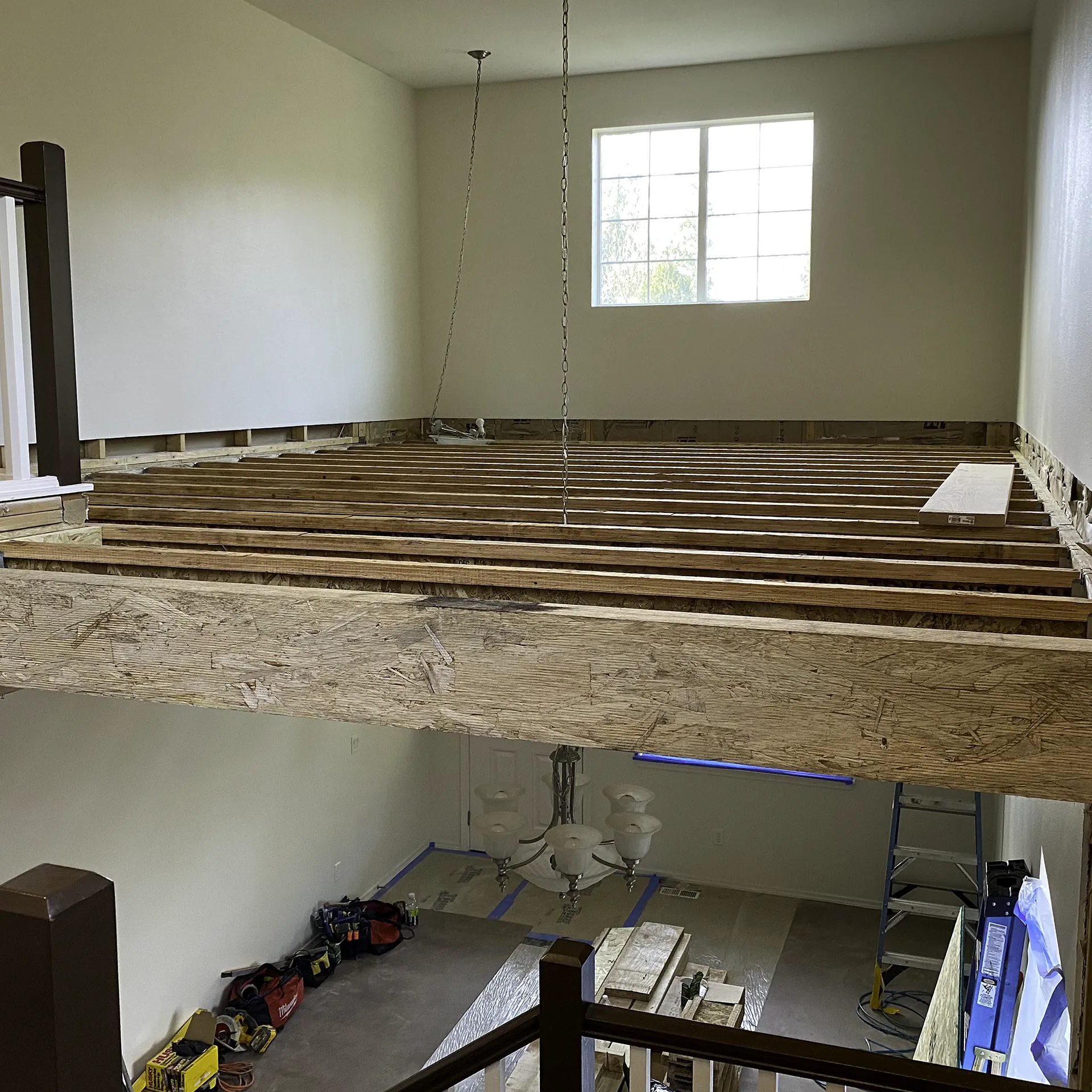 Engineered floor joists installed across the former two-story living room