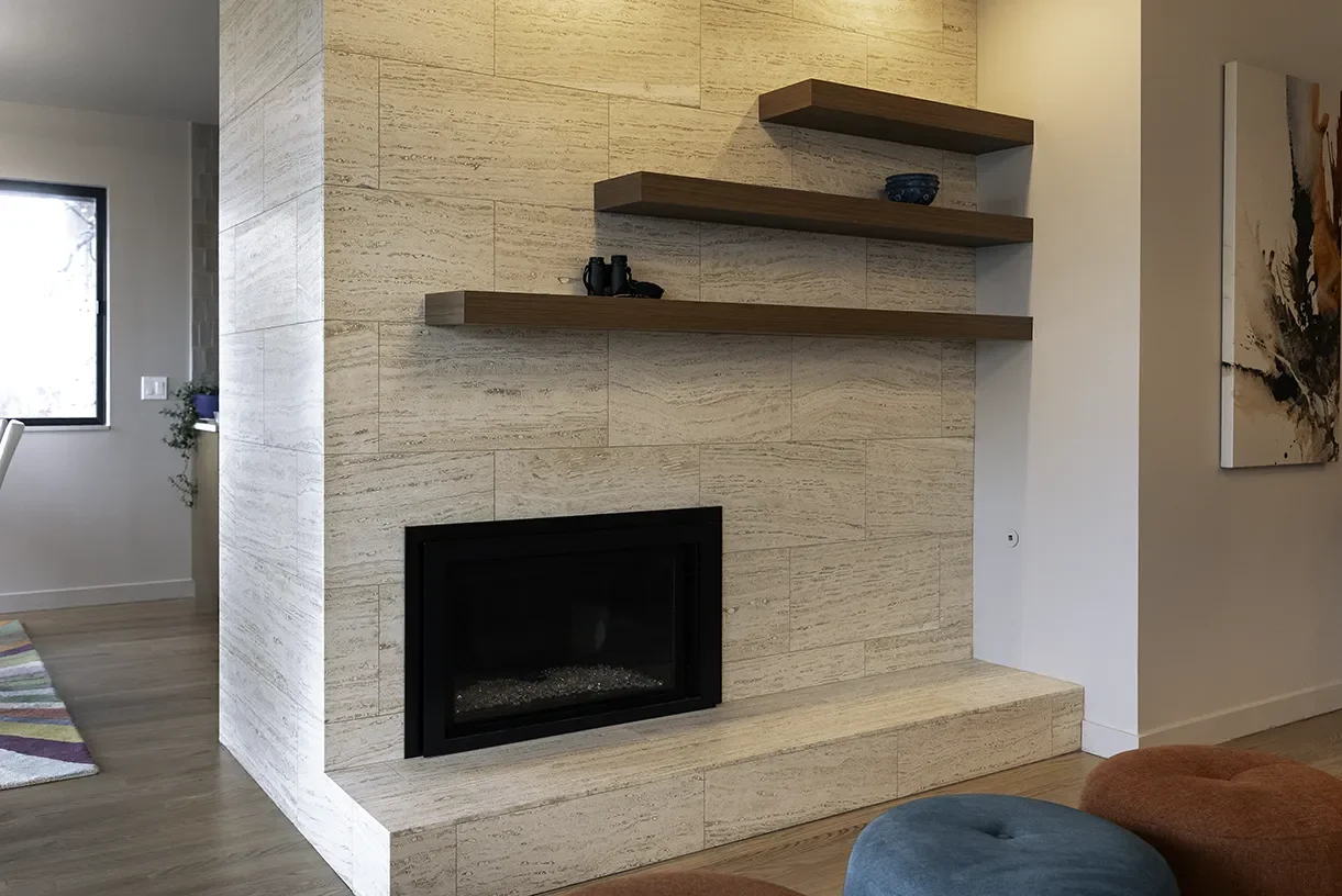 After: Modern fireplace with travertine and walnut shelves