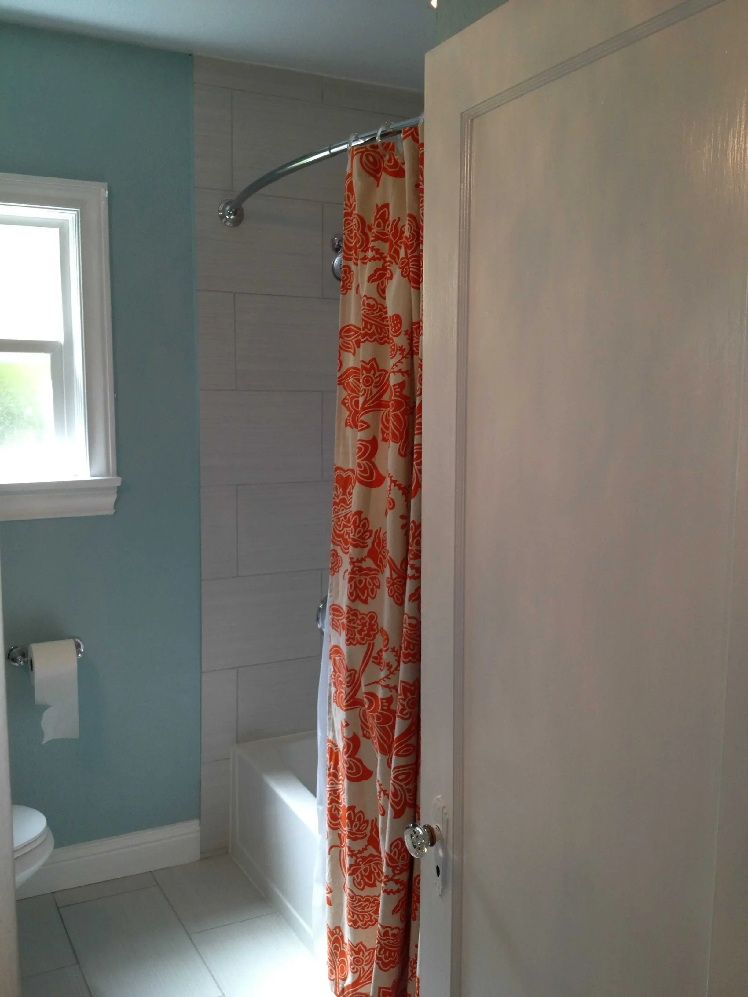 We removed the dropped ceiling over the tub for a more spacious feel